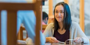 Girl at table in Ridington Reading Room