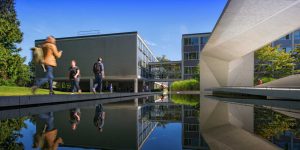 Students walking past the Buchanan Courtyard on the Vancouver campus at UBC on a sunny day