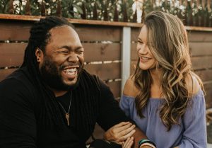 A couple laughs together.