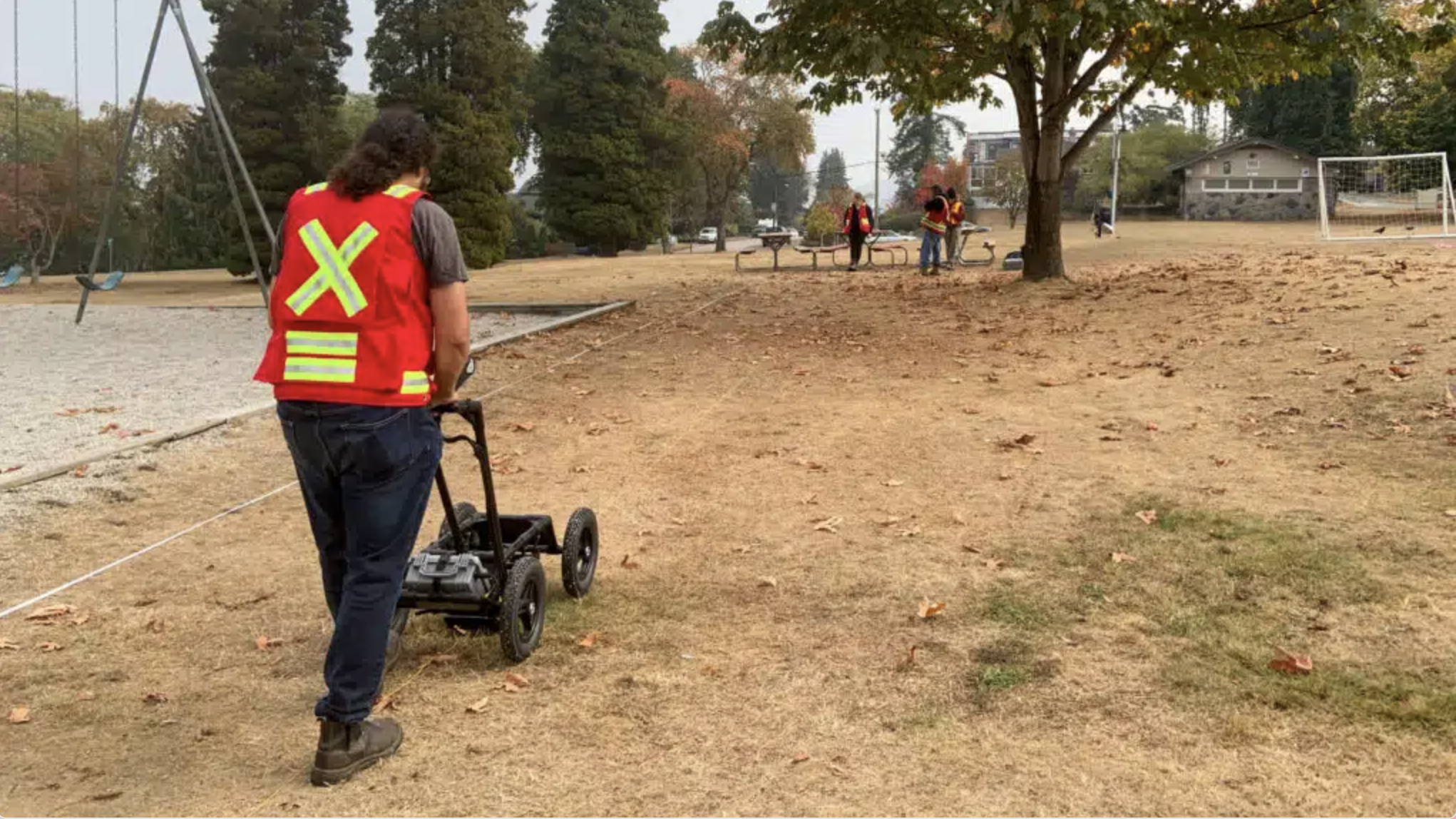 Person using a ground penetrating radar (GPR) used to locate and identify unmarked graves in Musqueam’s cemeteries