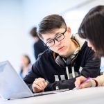 Two students working together in class.